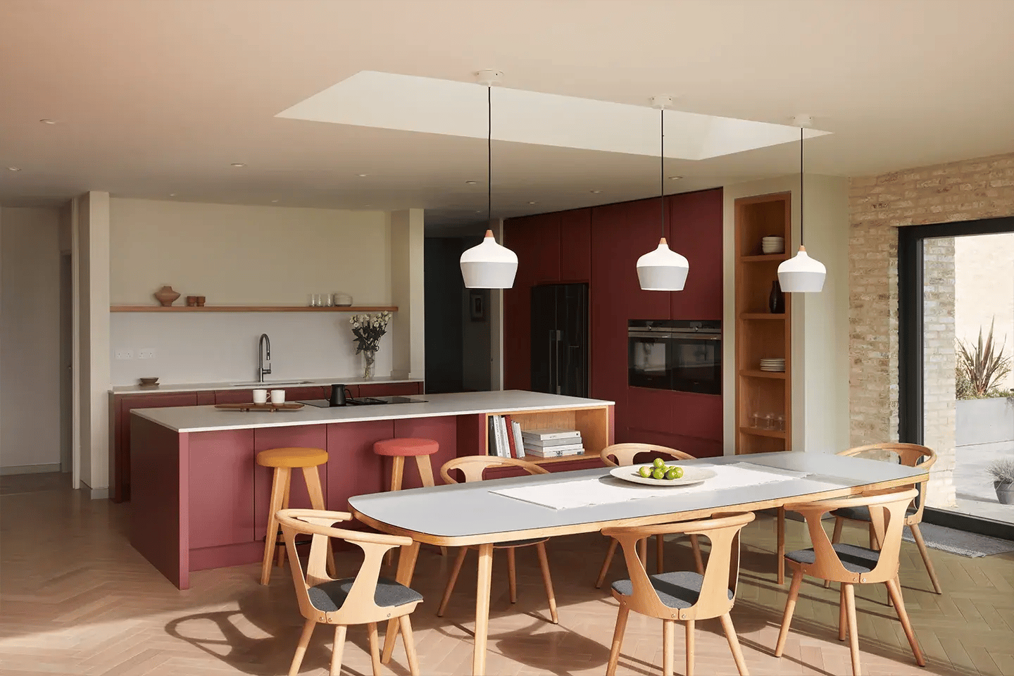 Caesarstone Fresh Concrete worktops in a dusty red modern kitchen
