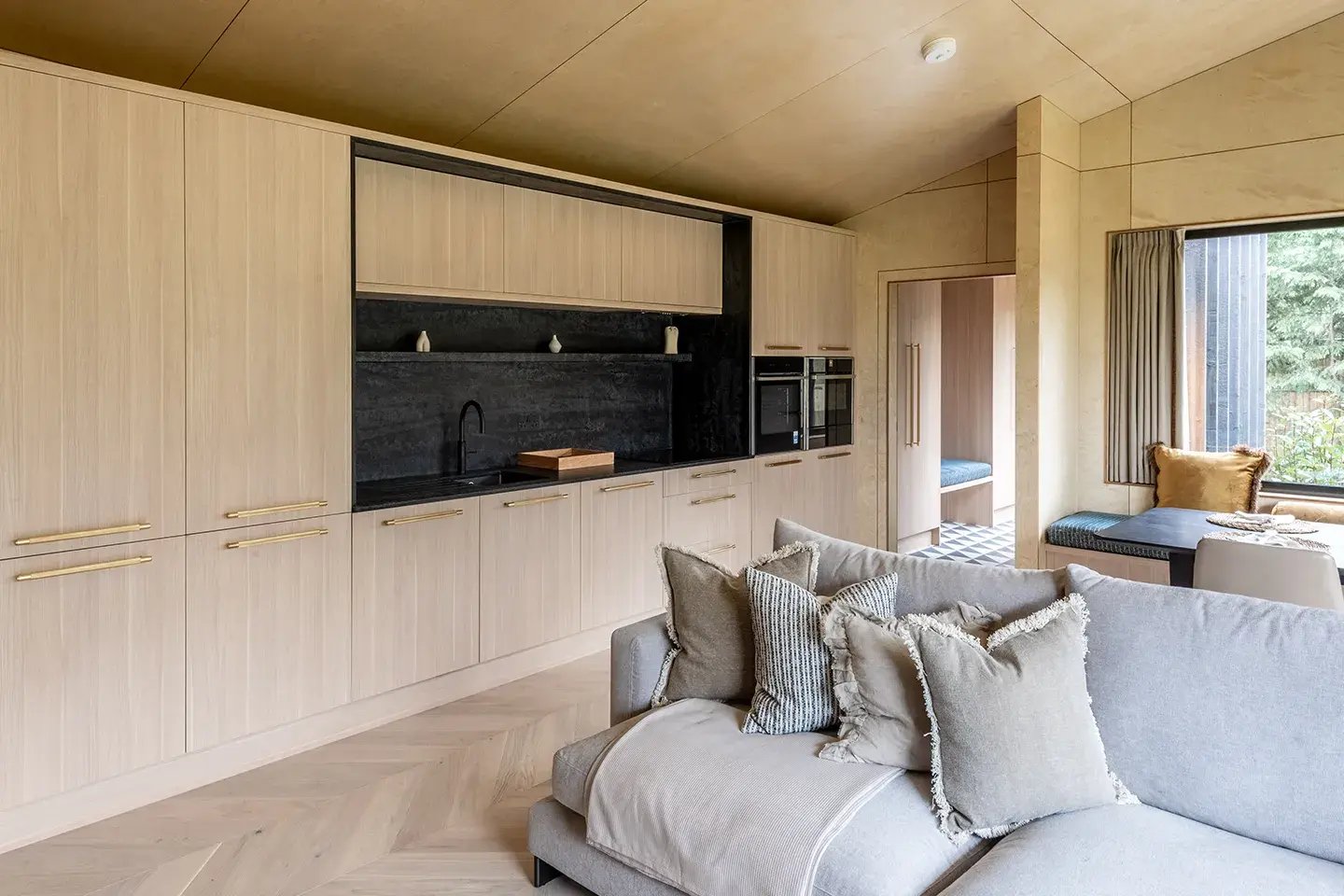 Caesarstone Black Tempal worktops in an open-plan kitchen