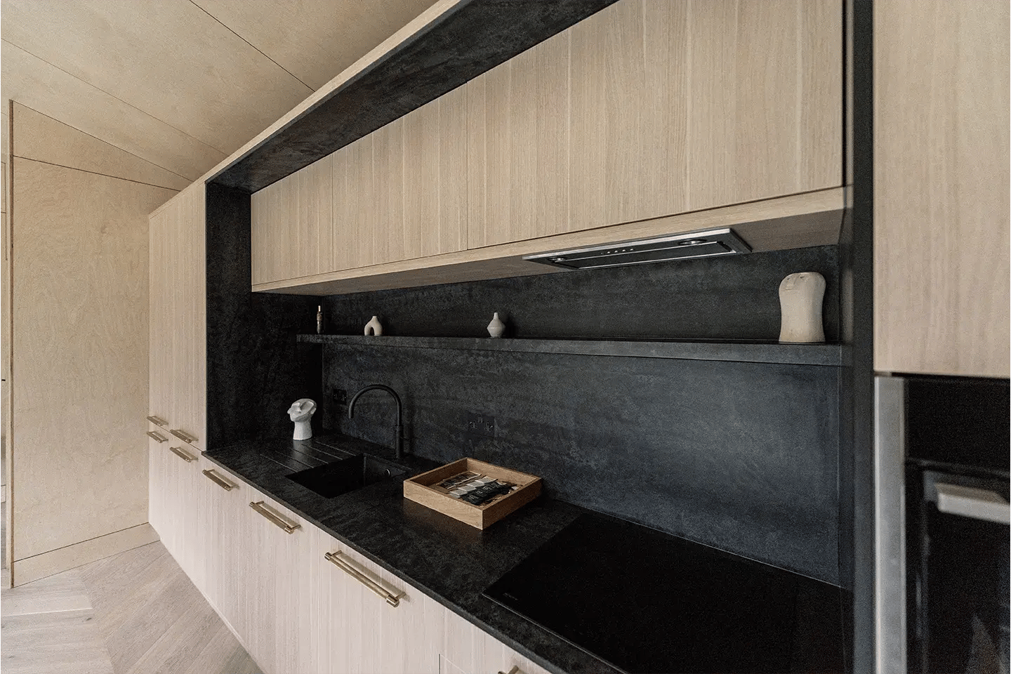 Close-up of Caesarstone Black Tempal kitchen worktops and splashback