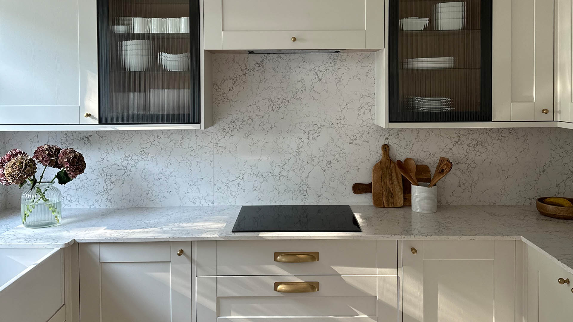 Caesarstone Arabetto quartz worktop and splashback in transitional kitchen